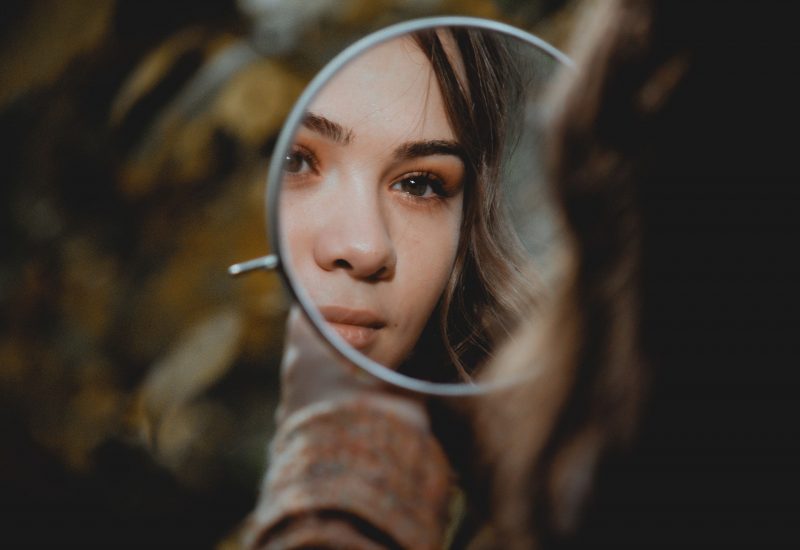 Young woman looking in a mirror